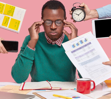 African american man sitting desk surrounded with gadgets papers 1 360x320